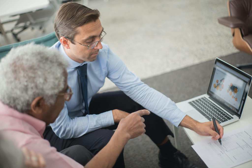 Financial adviser helping his client manage finances